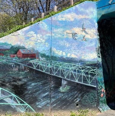 A portion of the Heroes mural at the Hedges Ave underpass of the rail trail