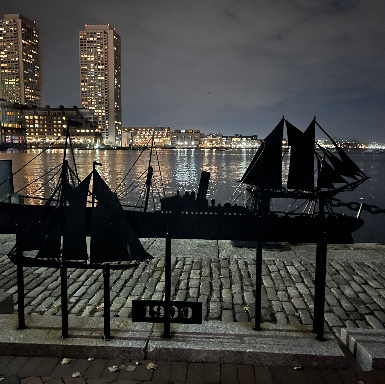 Image of Boston harbor at night with a view of the city