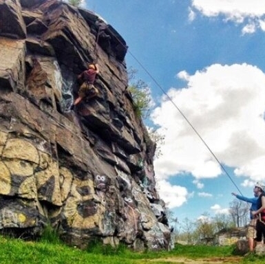 A group of people having fun top-roping at Quincy Quarries.