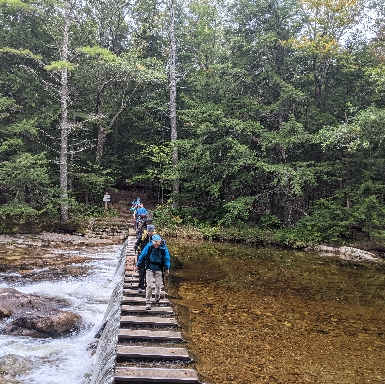 Crossing the bridge at Cold River Camp